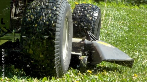 The hole where the grasses are coming out of the lawn mower while moving forward cutting grasses in Estonia