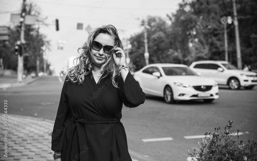 Beautiful woman on a walk in the city. Autumn- Winter time. A nice middle aged plus size woman at the street. Citizen lifestyle Beautiful woman on a walk in the city. Autumn- Winter time. A nice middle aged plus size woman at the street. Citizen lifestyle