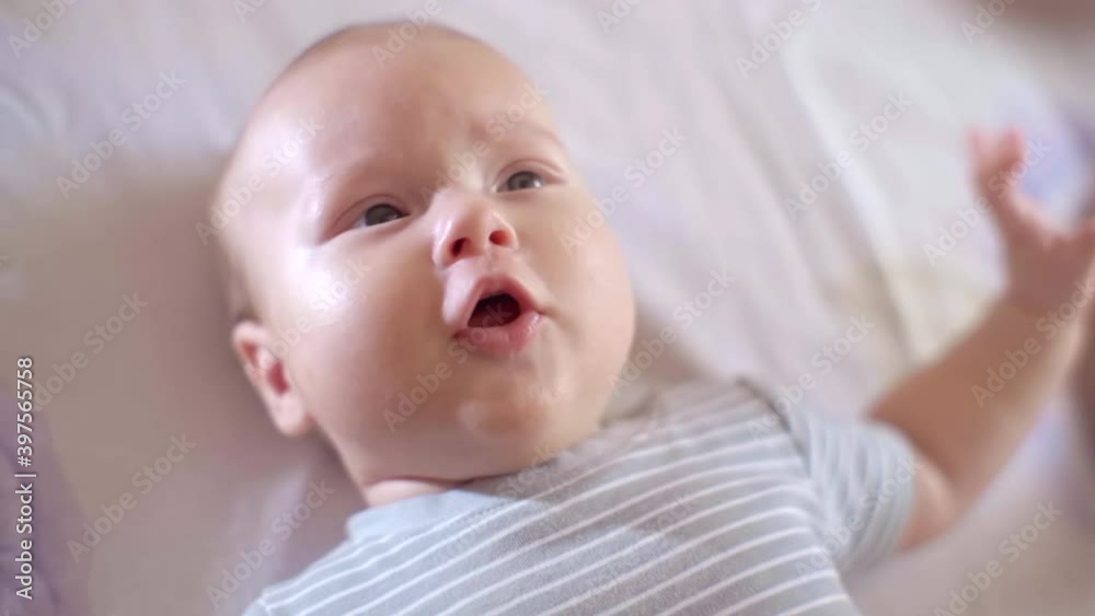 Nice Little Baby Lying in the Crib, Close-up of the Emotional Face of a Child Nice Little Baby Lying in the Crib, Close-up of the Emotional Face of a Child