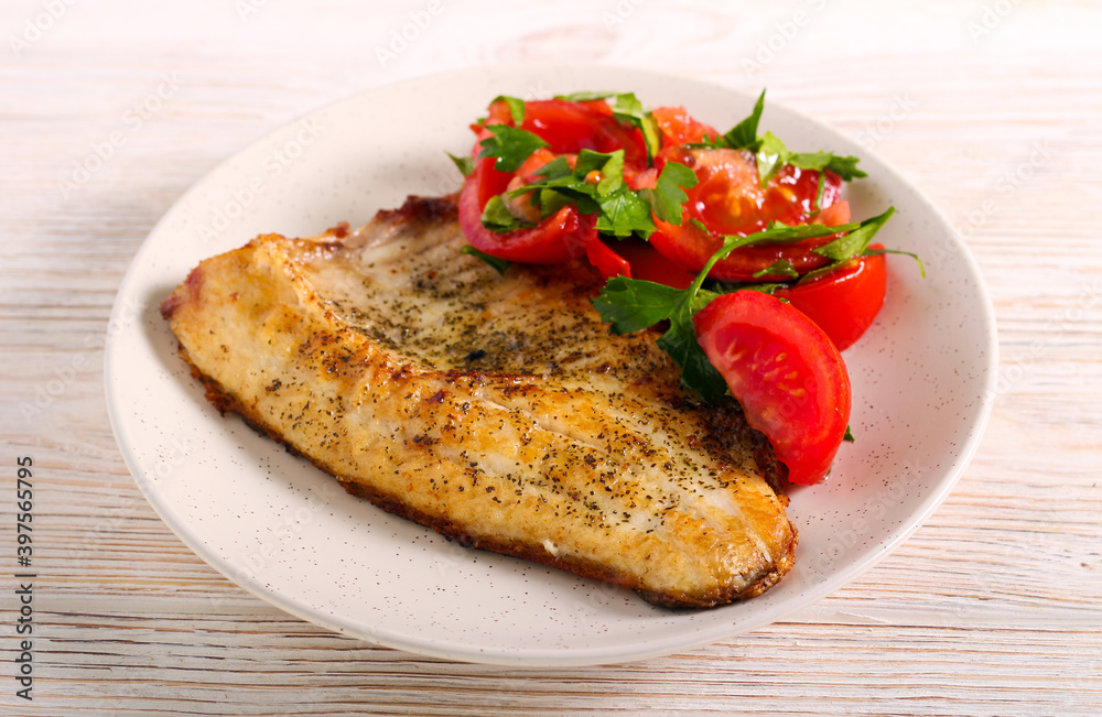 Fried carp fish with salad served Fried carp fish with salad served