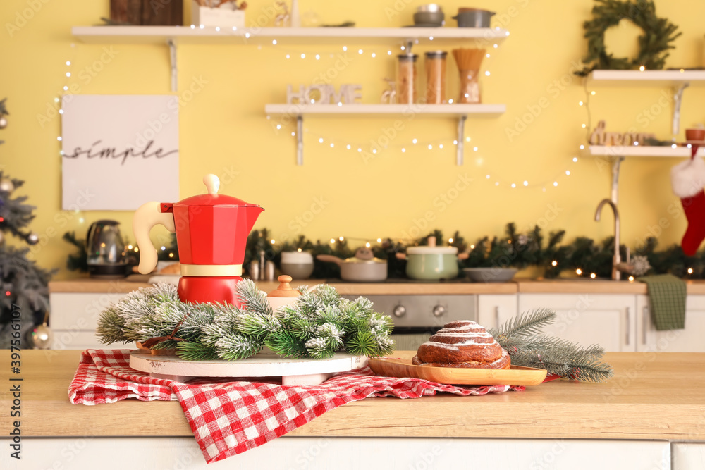 Coffee pot with Christmas decor on table in kitchen Coffee pot with Christmas decor on table in kitchen