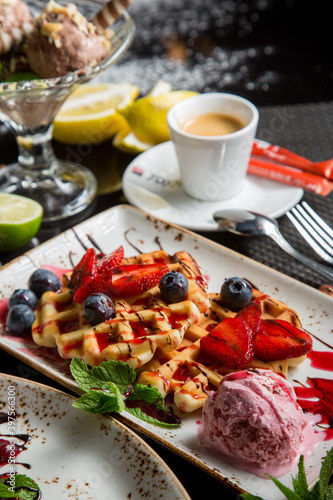 sweet Viennese waffles with syrup and sauce. Fresh fruit and berries in dessert. sweet dessert.