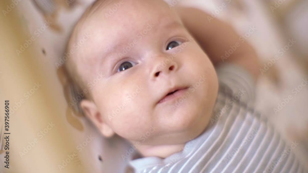 Close-up of a Nice Little Kid. Baby Lies In Crib On His Back Close-up of a Nice Little Kid. Baby Lies In Crib On His Back