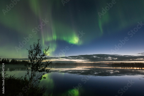 Northern lights reflected in the water © DANIL
