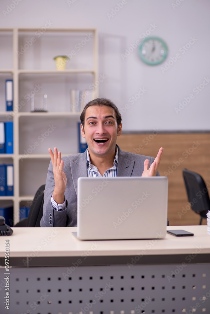 Young male employee working in the office Young male employee working in the office