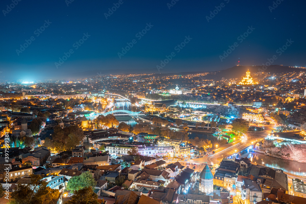 Naklejka premium Tbilisi, Georgia. Elevated Rooftop View Of Famous Landmarks In Night Illuminations. Georgian Capital Skyline Cityscape