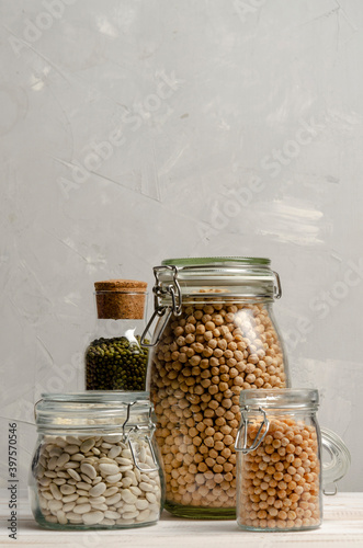 Jar with beans and legumes on gray background with