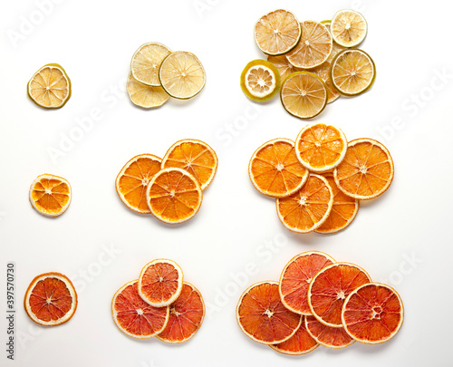 Colorful dry citrus fruits on white background. Flat lay. Christmas. lime, orange, red