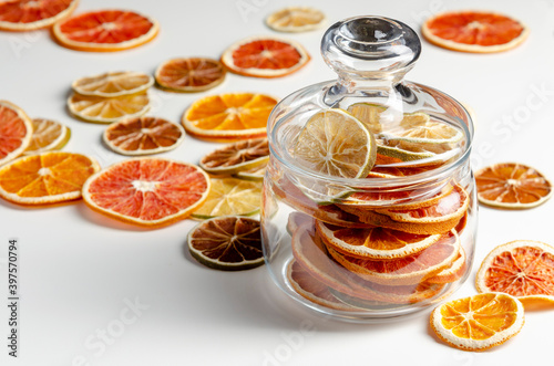Jar of dry citrus fruits on white background. Flat lay. Christmas. lime, orange, red