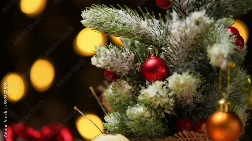 christmas lights and decorated xmas tree with snow on branches closeup - new year or holiday decoration concept