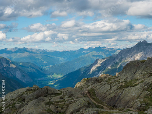 Summer view of Stubai valley from Bremer Hutte at hiking trail, Stubai Hohenweg, rock, boulders and moutain peaks. Tyrol Alps, Austria