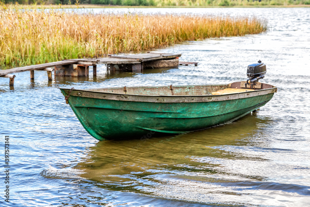 Fototapeta premium Landscape with plastic fishing motor boat on the lake