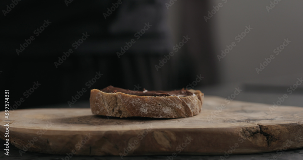 chocolate hazelnut spread on ciabatta slice on wood board chocolate hazelnut spread on ciabatta slice on wood board