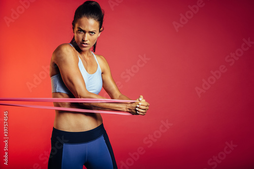 Woman exercising with resistance band photo