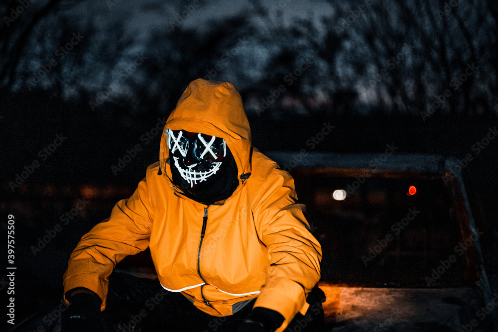 Purge mask, halloween with pumpkin. mask, creepy scary man. Corona, Funny, outside. Urban scene car Stock-foto | Stock