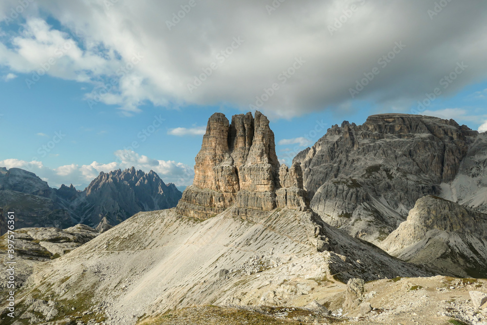 A panoramic view on Toblinger Knoten and surrounding mountains in Italian Dolomites. Difficult ad dangerous climbing route. Stony valley below. Few narrow pathways on the side. Freedom and serenity