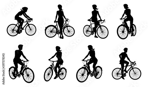 A set of bicyclists riding bikes and wearing a safety helmet in silhouette
