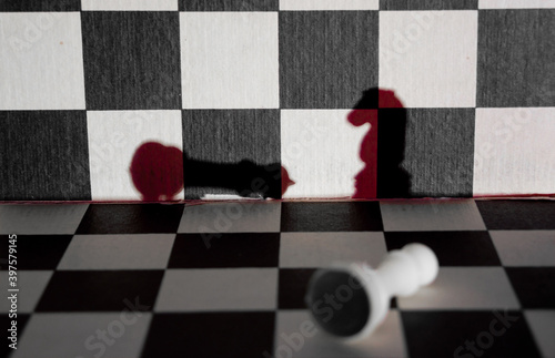 Chess knignt shadow checkmates white king