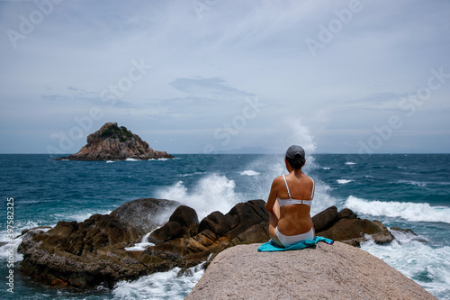Young woman watching the waves break