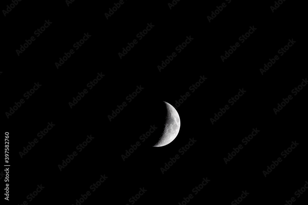 The growing moon in the black sky. The growing moon in the black sky.