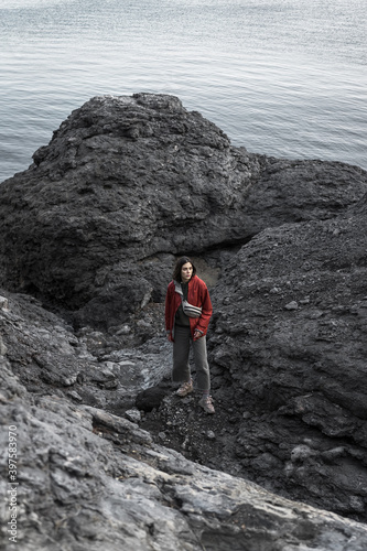 The girl makes her way through the rocky coast of the Black Sea. Novy Svet, Crimea. Clear Sunny day. Hiking, traveling, Freedom, Lifestyle concept. © Константин Сапрыкин