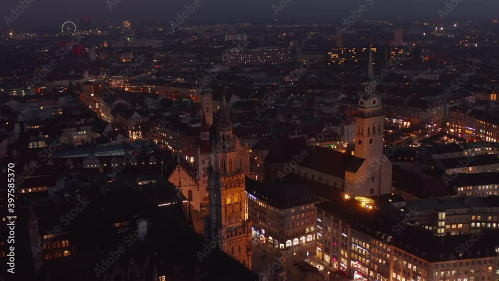 Flight over the Rooftops of Munich City at Night in Germany, Marienplatz and Beautiful Cathedrals with Scenic City lights glowing, Aerial Dolly forward Flight over the Rooftops of Munich City at Night in Germany, Marienplatz and Beautiful Cathedrals with Scenic City lights glowing, Aerial Dolly forward