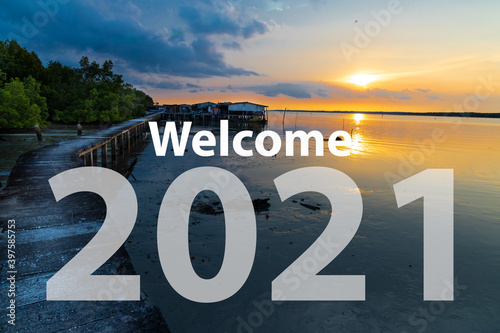 Welcome 2021 text against sunrise at scenic seaside in Malaysia