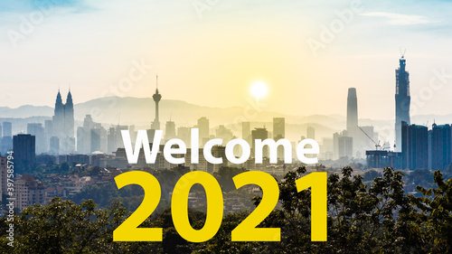 Photography Welcome 2021 text against Kuala Lumpur cityscape as background during sunrise