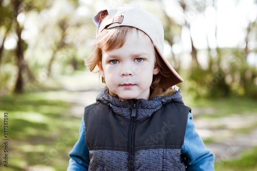 Cute preschooler boy in cap.