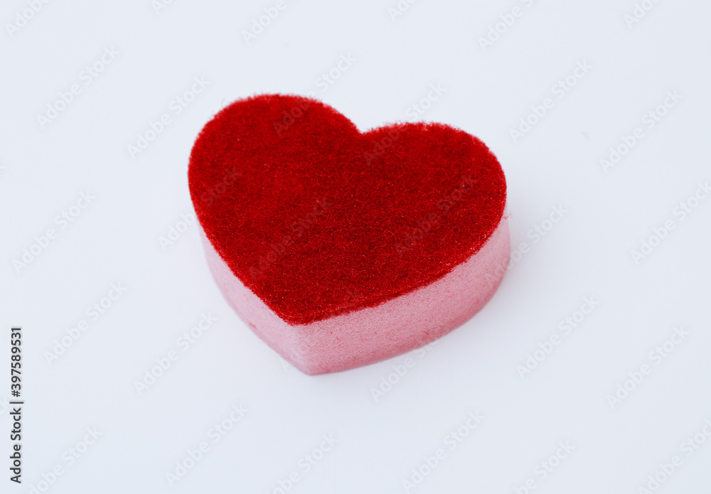 Fototapeta premium Red sponge for washing dishes on a white background. Household items
