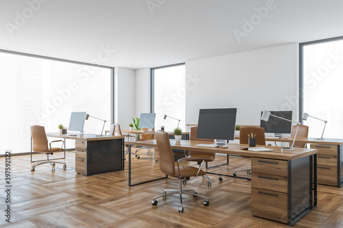 Office room with leather chairs and computers on table, white and wooden room
