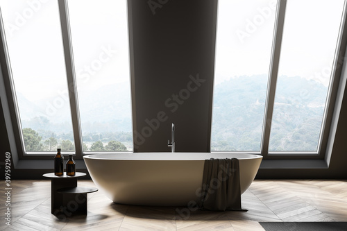 Attic gray bathroom interior with tub © ImageFlow
