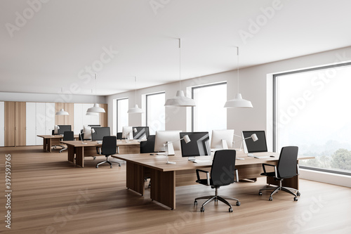 White and wooden open space office corner © ImageFlow