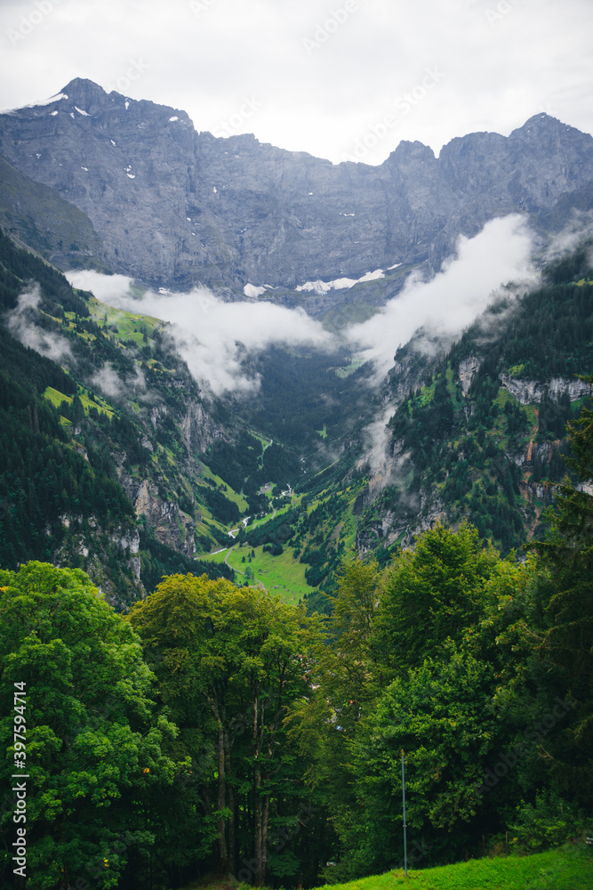 Fototapeta premium cloudy valley in switzerland swiss alps