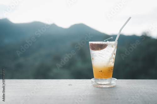 Transparent glass with tasty healthy freshly made passion fruit juice.