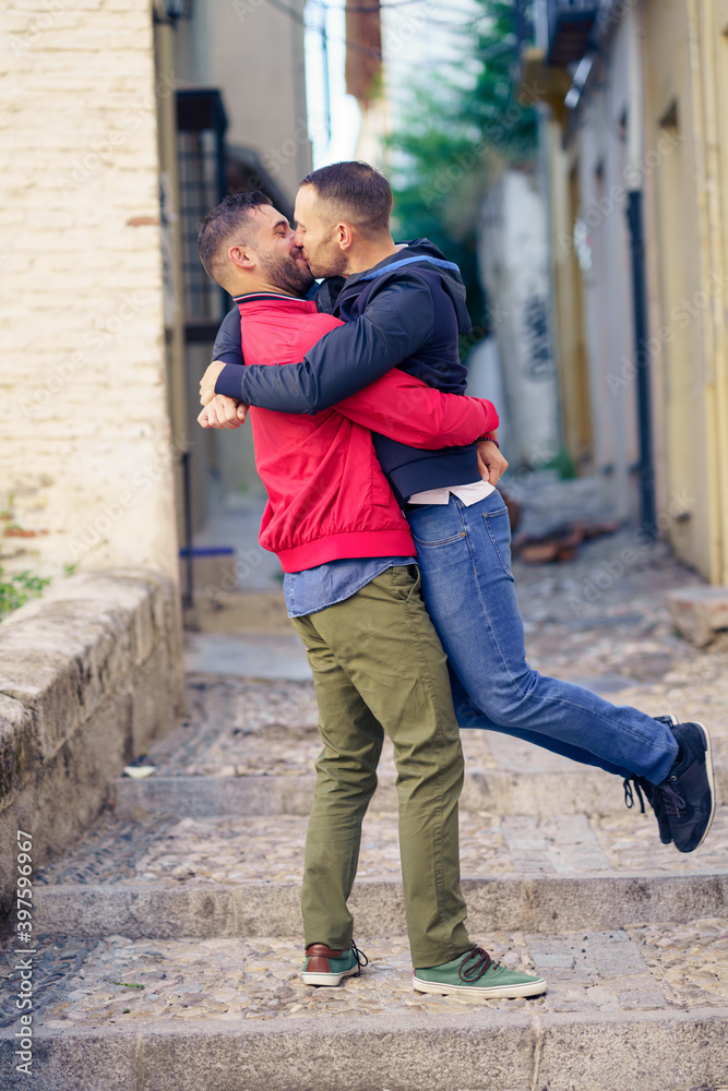 Gay couple in a fun and romantic moment in the street.