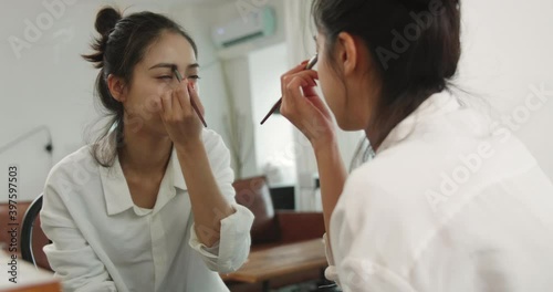 Wallpaper Mural one young beautiful Asian woman applying makeup in front of the mirror at home pretty girl Draw eyebrows  Torontodigital.ca