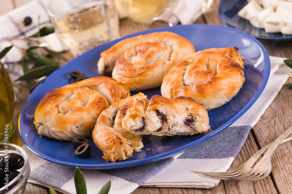 Pastry swirls with cheese and olive filling.
Pastry swirls with cheese and olive filling.