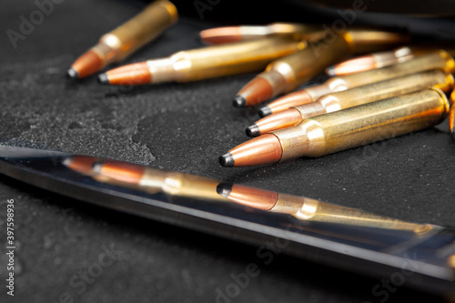 Cartridges for rifle or carbine on dark grey background close up