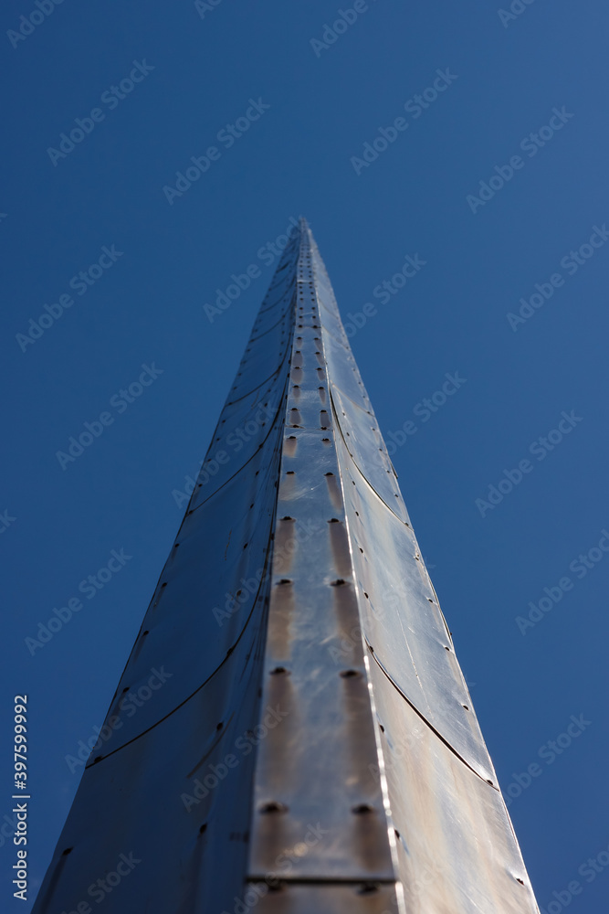Flagpole lined with metal sheets on sky background. Bottom view Flagpole lined with metal sheets on sky background. Bottom view