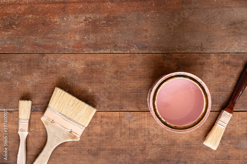 Paintbrush and painting color setup on rustic wooden background