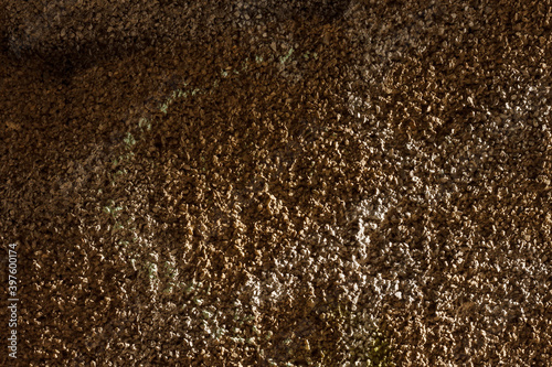 The surface of the plastered old brick wall. Texture of decorative plaster with a relief. Close-up.