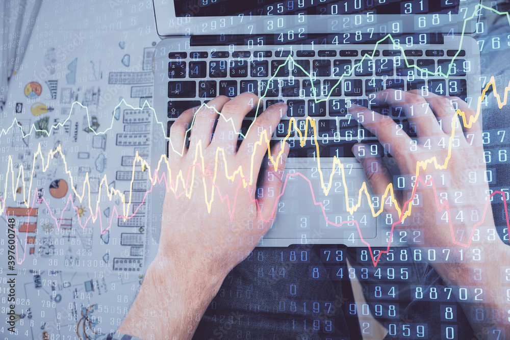 Double exposure of man's hands typing over laptop keyboard and forex chart hologram drawing. Top view. Financial markets concept. Double exposure of man's hands typing over laptop keyboard and forex chart hologram drawing. Top view. Financial markets concept.