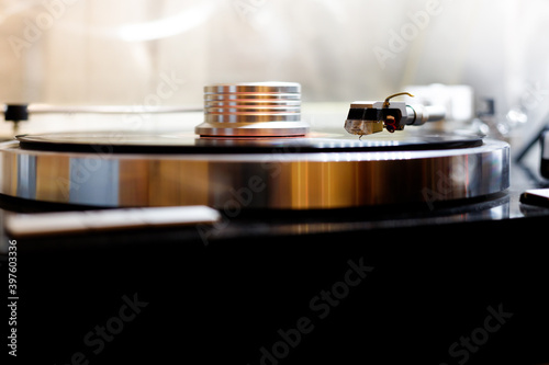vinyl player playing record, headshell close up photo
