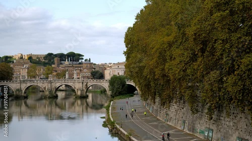 The sights on the wide sidewalks along the Tiber river that are favourite places to go jogging or ride bikes for Roman people