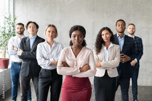 Determined Black Businesswoman Standing In Front Of Employees In Office