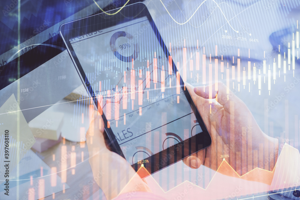 Double exposure of man's hands holding and using a phone and financial graph drawing. Analysis concept. Double exposure of man's hands holding and using a phone and financial graph drawing. Analysis concept.