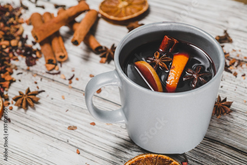 Cup of mulled wine on wooden table. Christmas and New Year background concept.