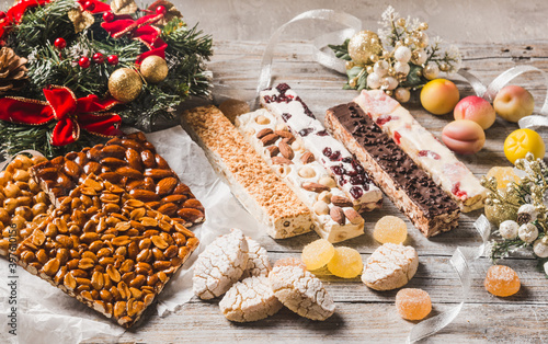 Italian Christmas desserts as different nougats with almonds, nuts, peanuts, marzipan. Traditional Italian Christmas sweets. photo