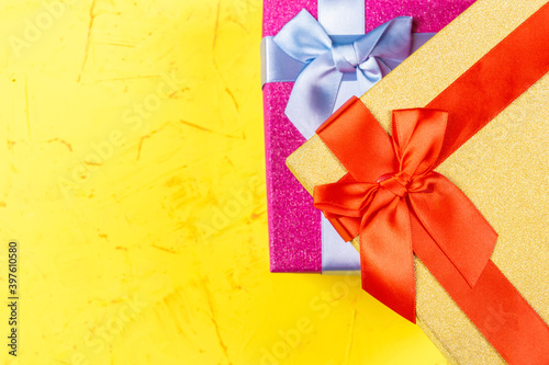 Colored square gift boxes on concrete background, flat lay, top view
